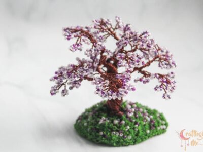 Miniature cherry blossom wire tree on a green patch