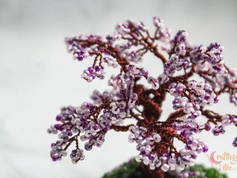 Miniature cherry blossom wire tree on a green patch