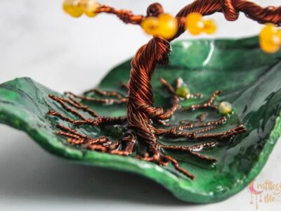 Miniature wire tree on an abstract leaf