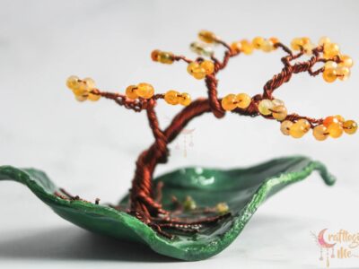 Miniature wire tree on an abstract leaf